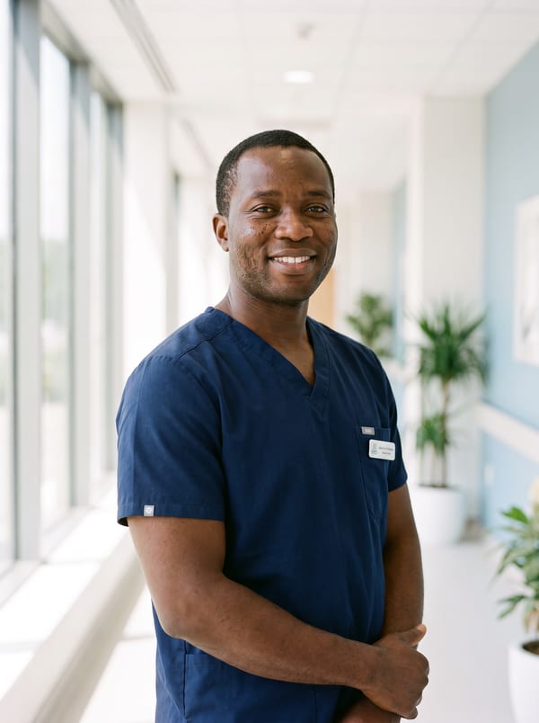 Dr. Marcus Oyelaran in navy scrubs